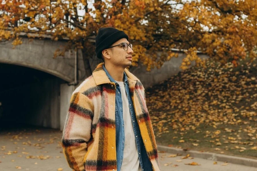 Man in a black beanie and plaid jacket