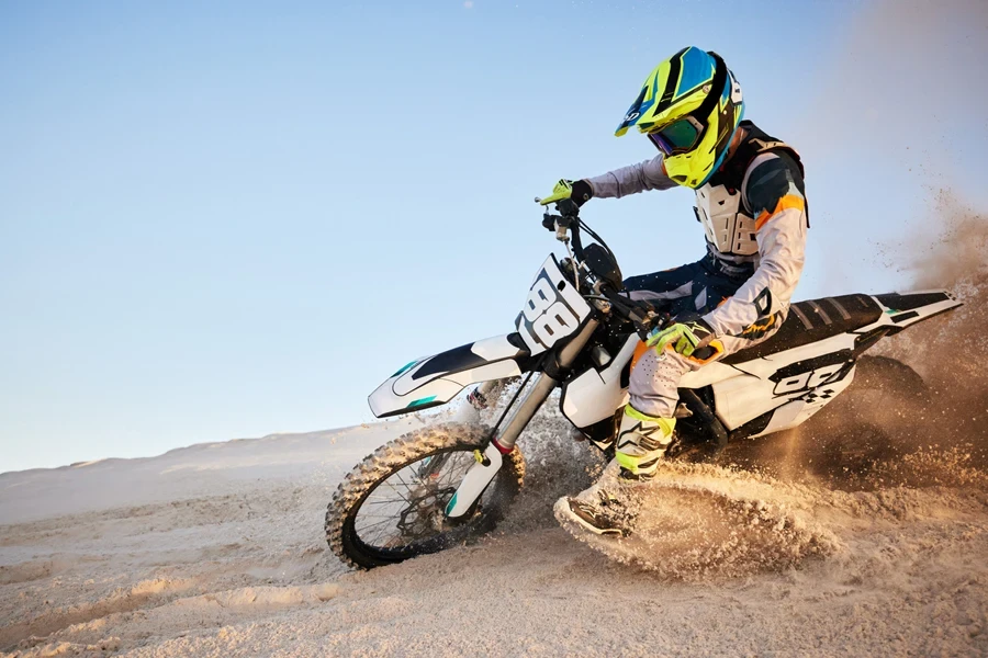 Man riding a dirt bike in the desert