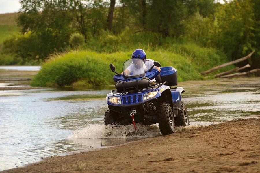 Man riding an ATV in a river