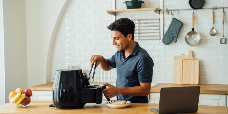 Man using a Beautiful Air Fryer in a kitchen