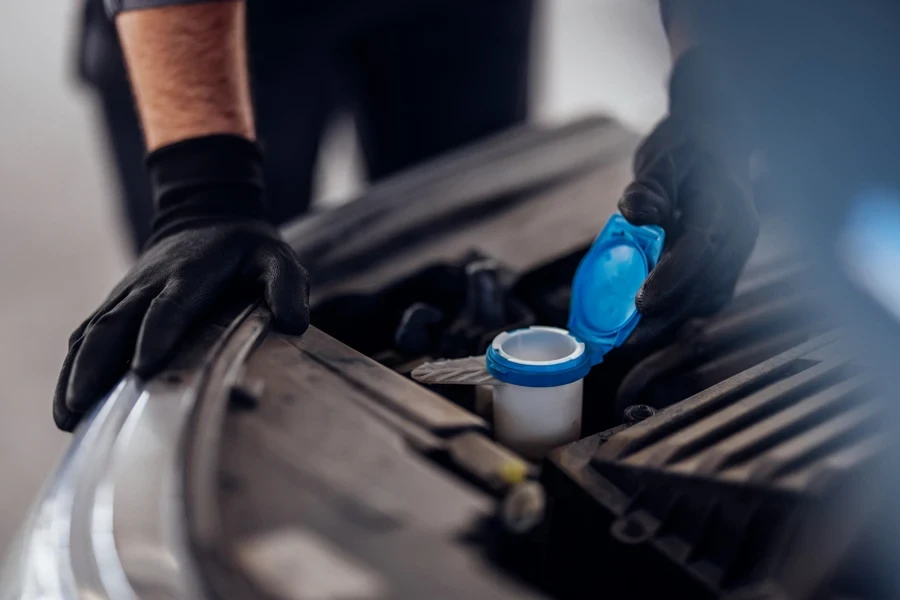 Mechanic checking car coolant level