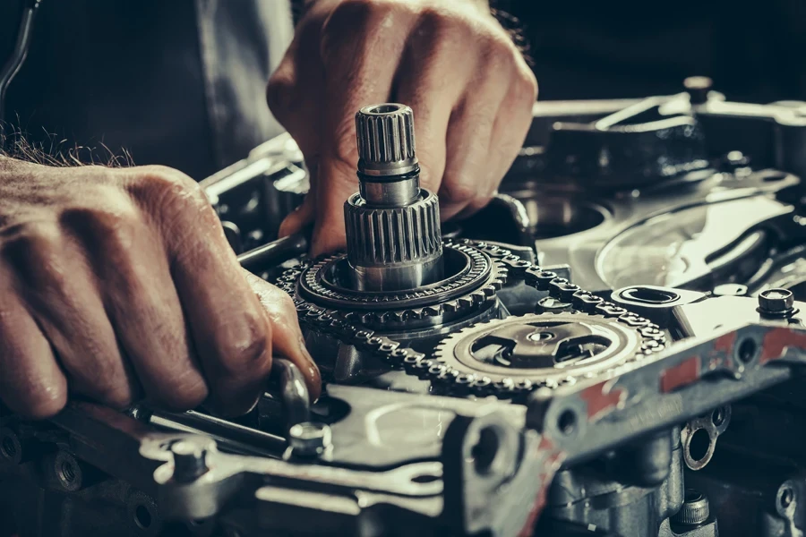 Mechanic fixing a car gearbox