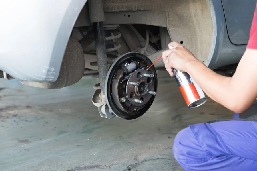 Mechanic spray chemical to clean brake