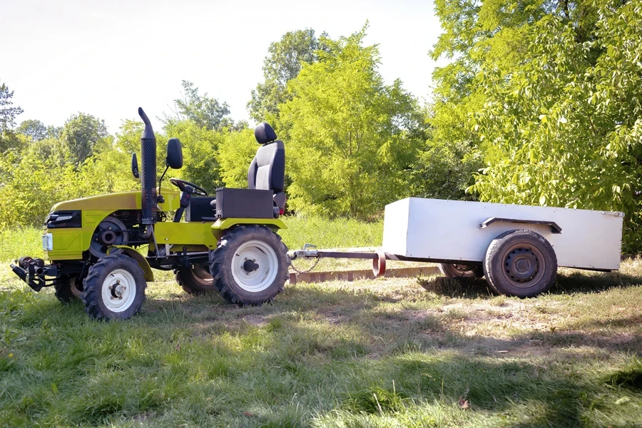 Mini tractor attached to a trailer