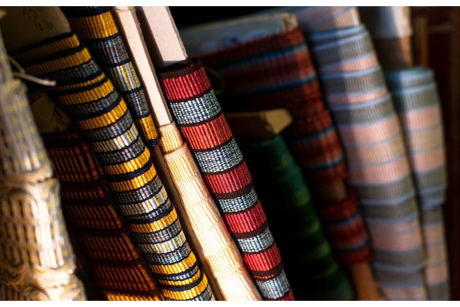 Multi-Colored And Patterned Rolls Of Ribbon On A Shelf