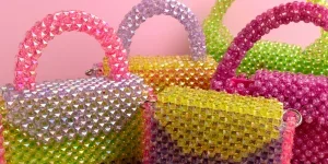 Multicoloured beaded bags on a table
