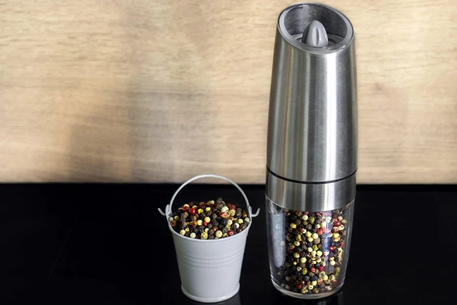 Pepper grinder with gravity-activated feature on dining table
