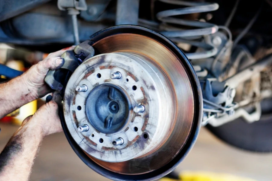 Person repairing a car’s braking system