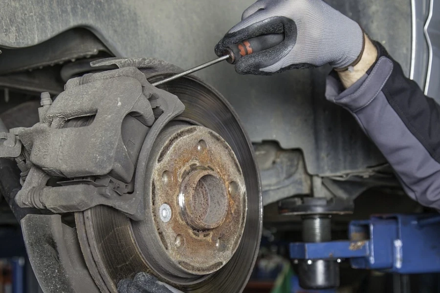 Person working on a brake disc