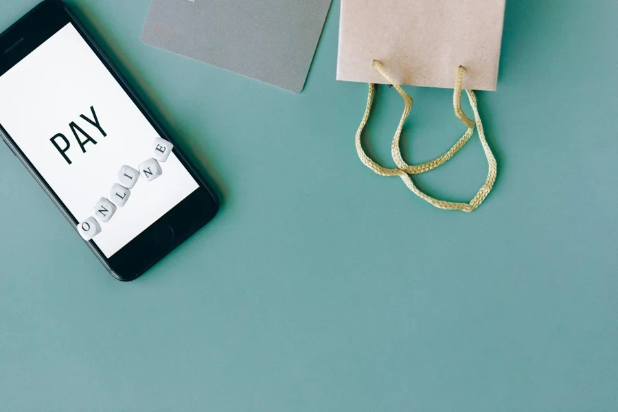 Phone and shopping bags on a green background