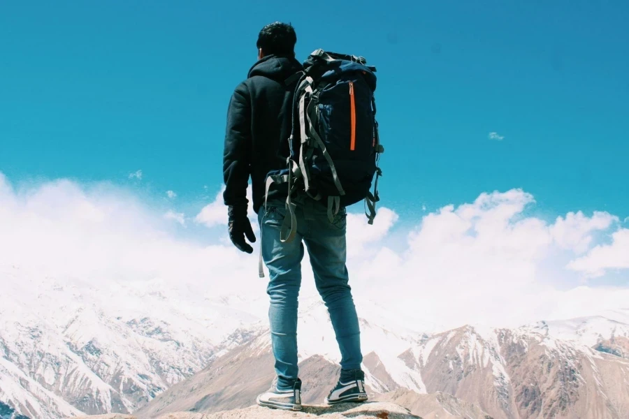 Photo of Man Standing On Top Of Mountain