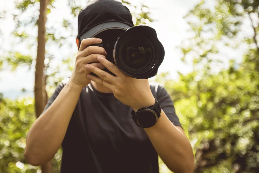 Photographer pointing camera at viewer
