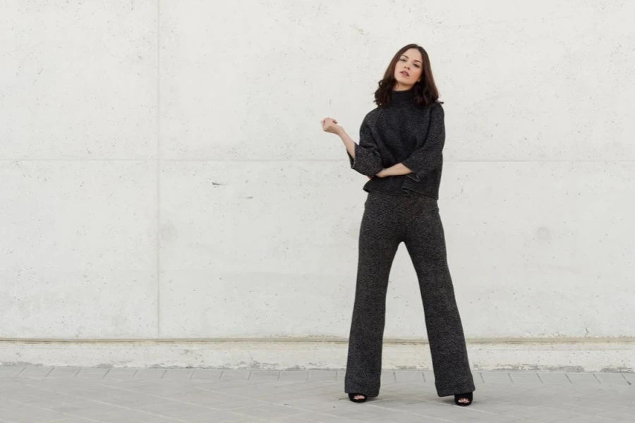 Portrait Of Young Woman Standing Against Wall