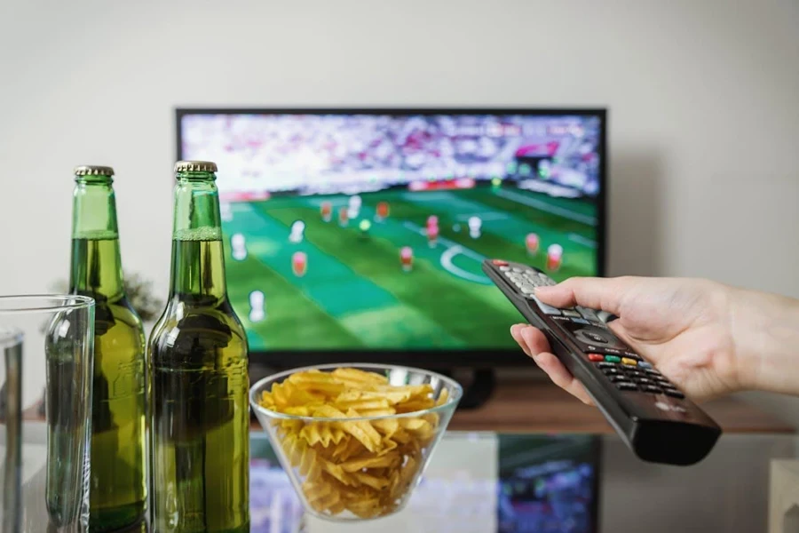 Remote pointing at TV with sports on screen