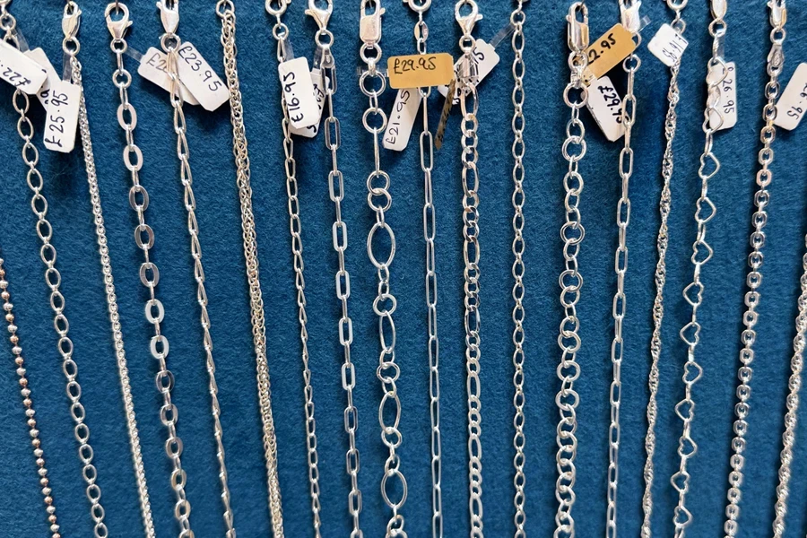 Selection of silver chain necklaces on display in shop