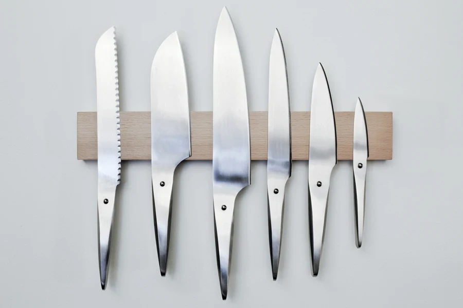 Selection of stainless steel knives on display on wall