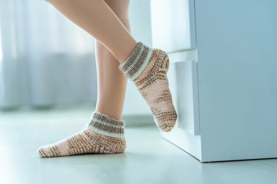 Short alpaca grippy socks being worn by professional woman