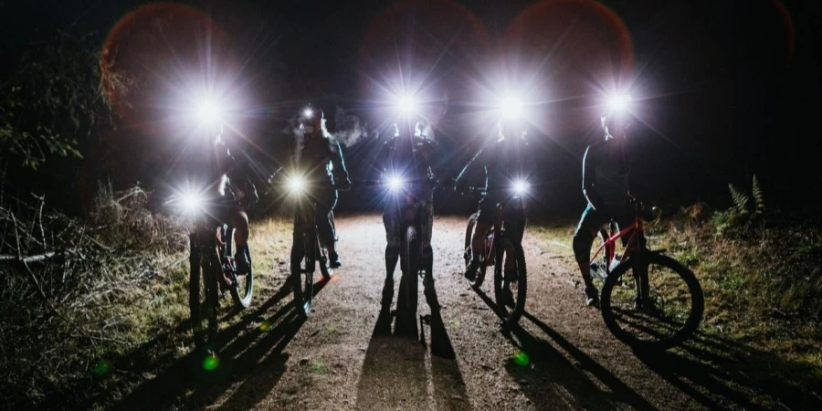 Silhouette of women's mountain bike club during night ride