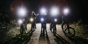 Silhouette of women's mountain bike club during night ride