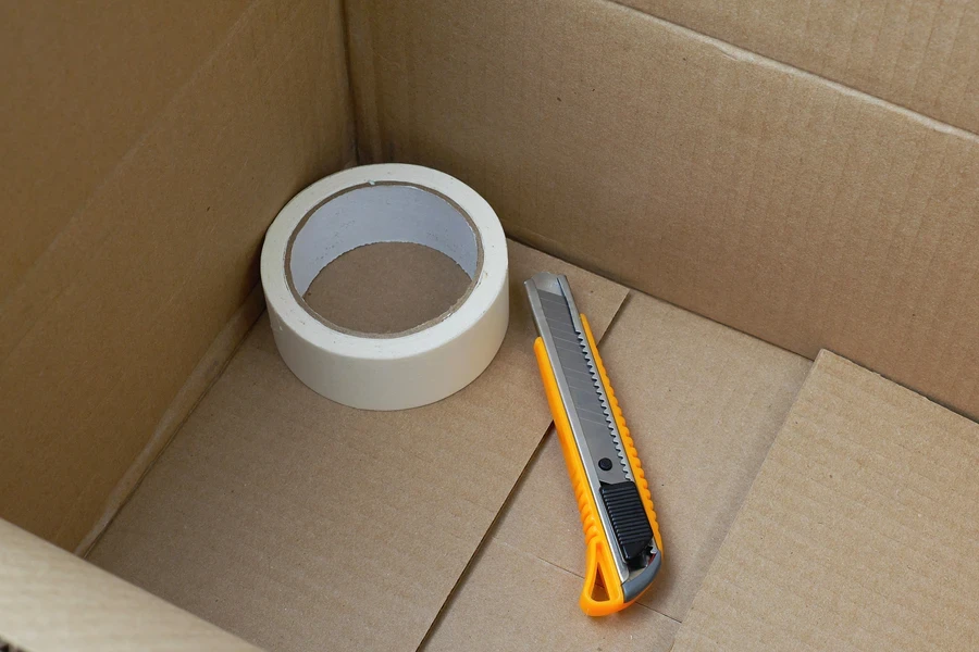 Snap-off blade utility knife in box with tape