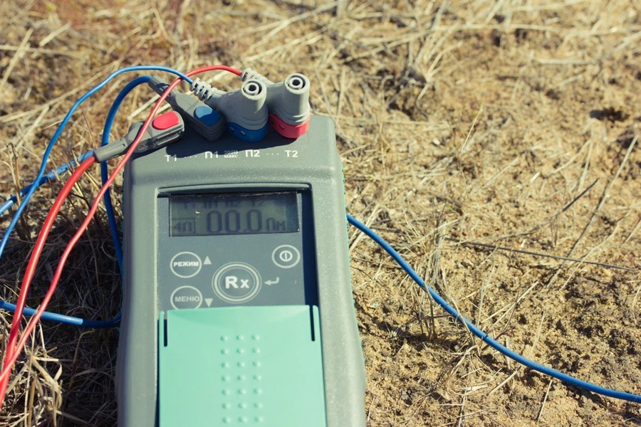 TDR soil moisture detector on ground with various wires