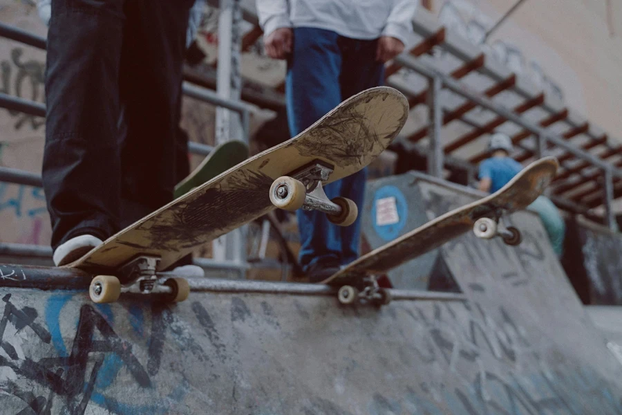 Teenagers skateboarding on a graffiti-covered ramp, showcasing urban culture