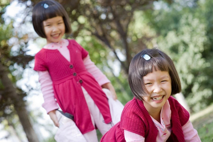 Two beautiful girls playing while rocking bouncy bobs