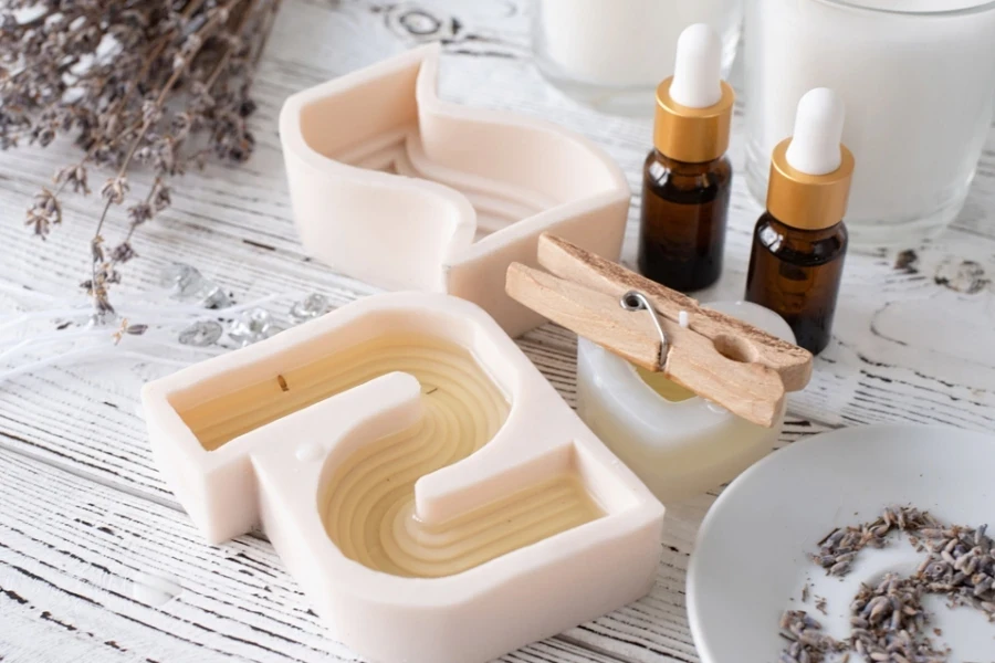 Two bottles of essential oils near craft supplies