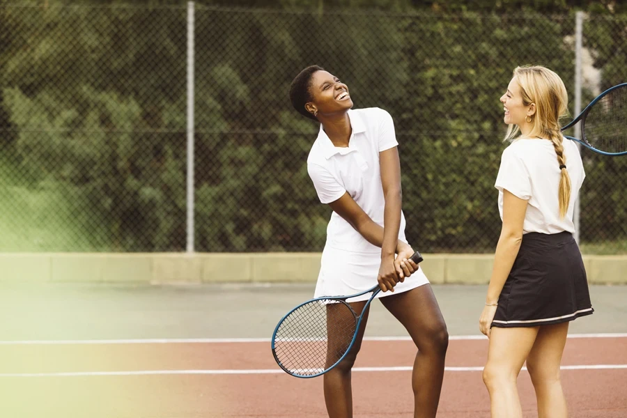 Two women talking on court at public tennis club
