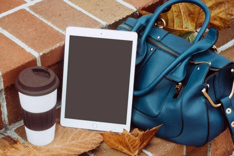 White Ipad Besides Blue 2-way Leather Bag
