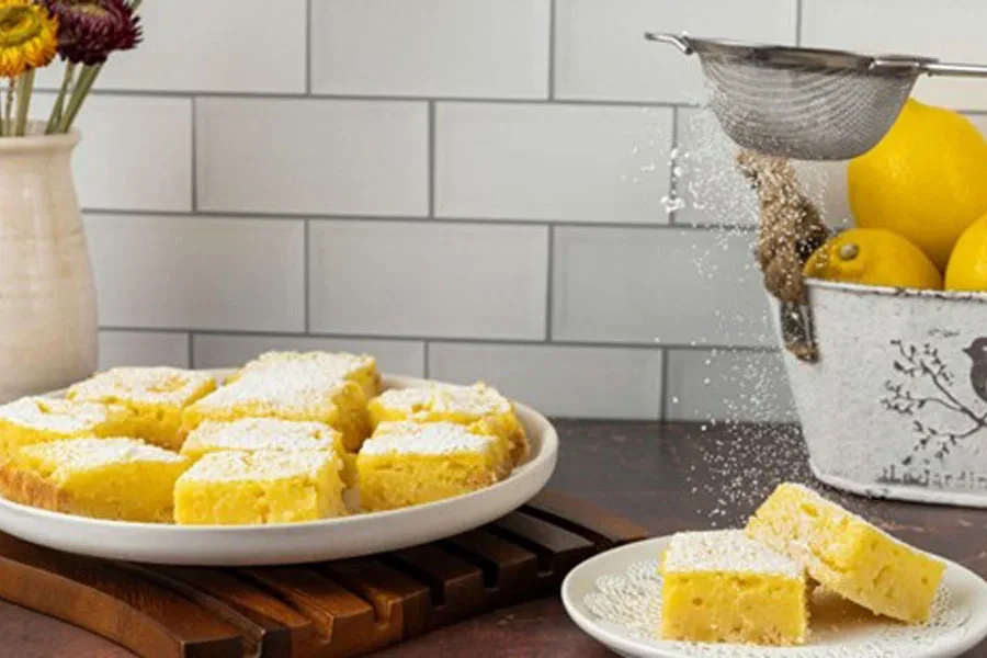 White pan with freshly baked cakes on a wooden trivet