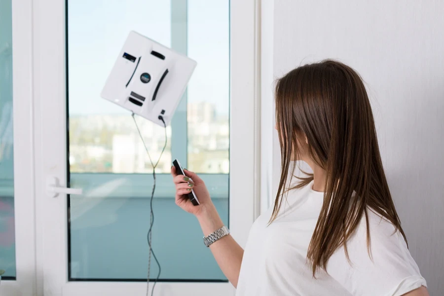 Woman controlling a window-cleaning robot