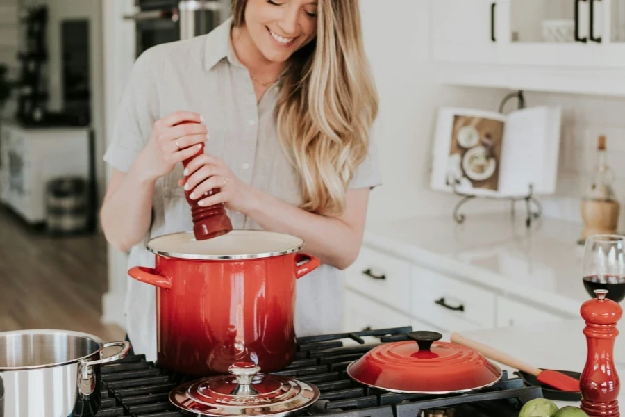 Woman cooking with twist salt and pepper mill