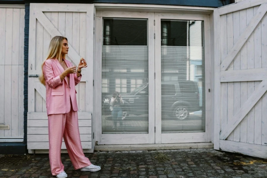 Woman in Pink Clothes Posing by Wooden Door