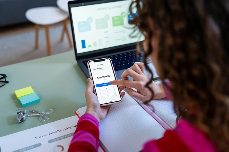 Woman initiating a transfer on her phone
