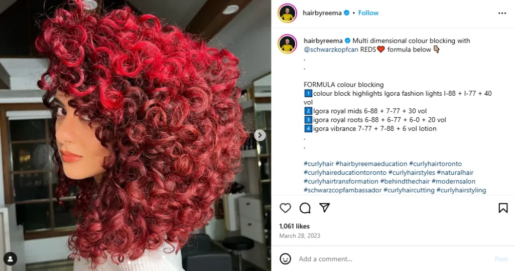Woman posing with a full head of red curly hair