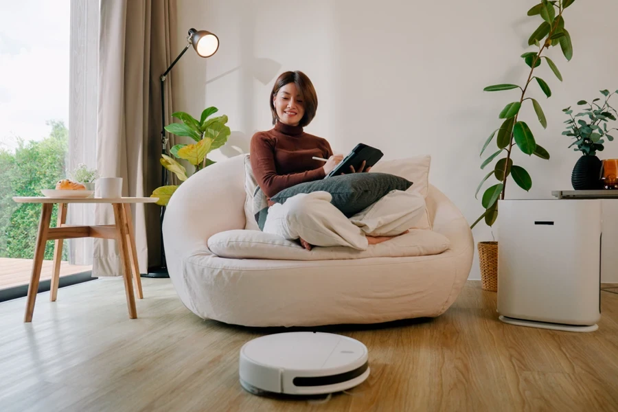 Woman watching her smart vacuum cleaning