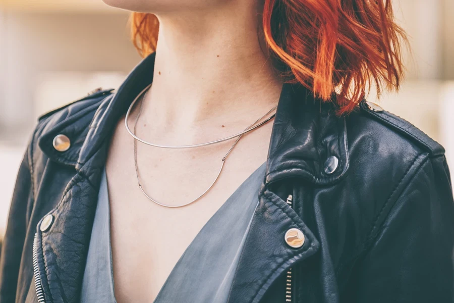 Woman wearing black leather jacket and fine jewelry