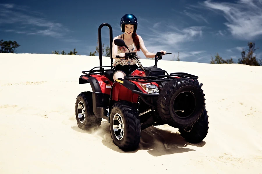 Young female riding an ATV on a beach