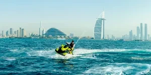 a man riding a jet ski on top of a body of water