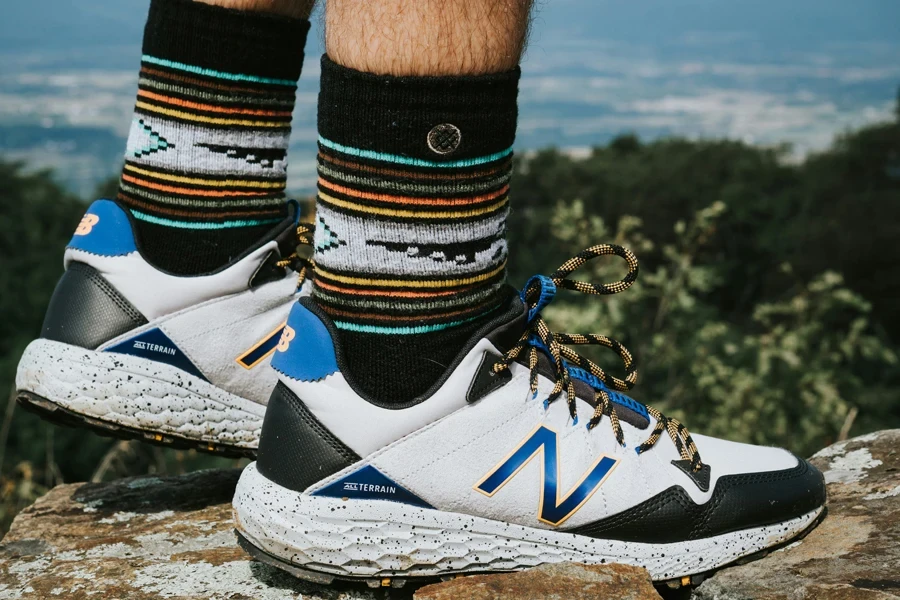 person wearing white blue and black nike athletic shoes