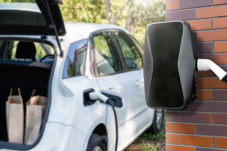 A White car charging using an EV home charger