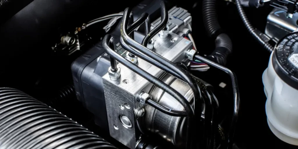 A close-up of an ABS module in an engine bay