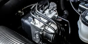 A close-up of an ABS module in an engine bay