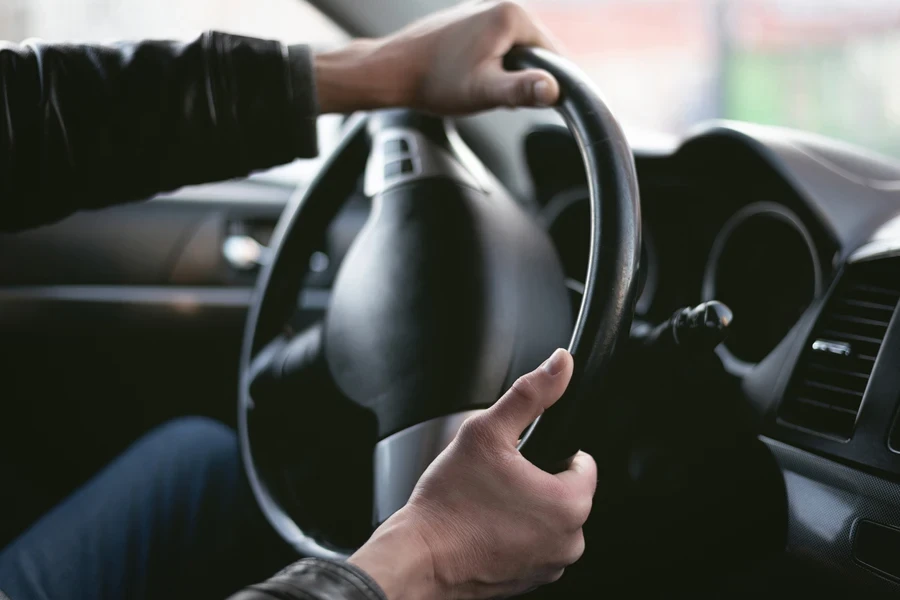 A driver is drifting his car in a sharp turn
