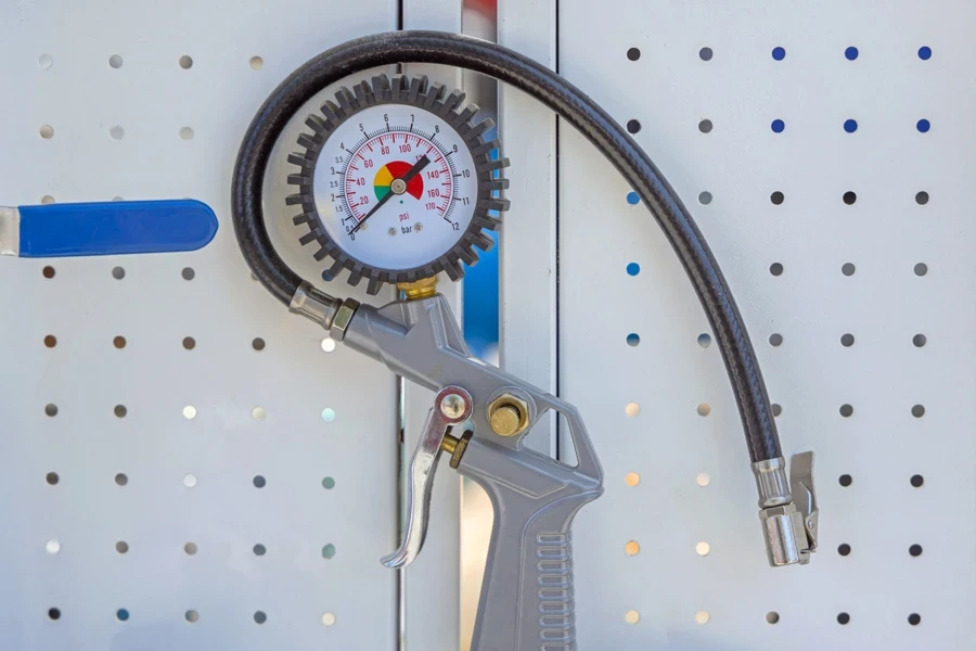 A gray tire inflator resting on a surface