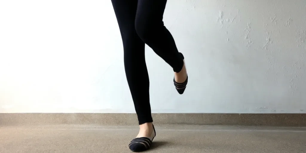 A lady's legs in mesh ballet flats