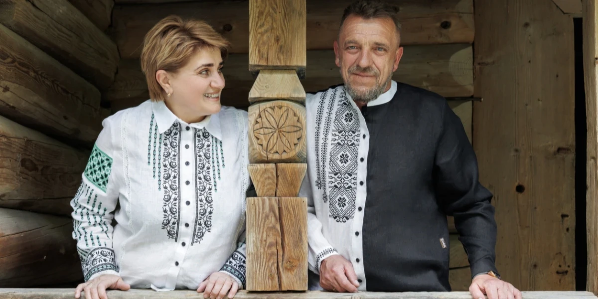 A man and woman wearing embroidered shirts