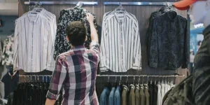 A man checking clothes in a store