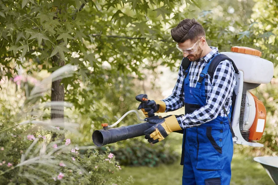A man using a modern backpack leaf blower